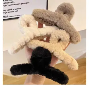 Plush hair claw detail closeup, soft furry shark clip, autumn and winter fashion hair accessory display.