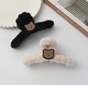 Cute plush hair claw clip with brown bear patch, fluffy winter hair accessory for women.