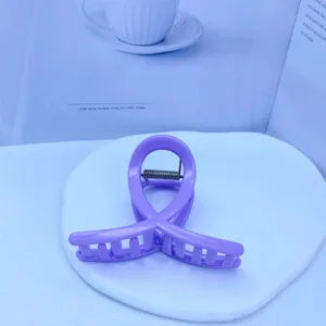 Detail shot of a sweet purple hair claw clip, featuring a stylish loop design for elegant buns.