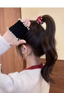 Detail view of Korean style red pearl hair scrunchie, elegant and elastic hair tie accessory.