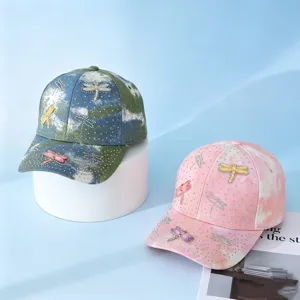 Detail view of fashionable rhinestone dragonfly tie-dye baseball cap, outdoor casual sun hat.