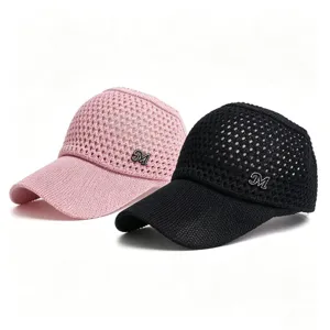 Detailed view of the hollow mesh empty-top sun hat with rhinestone logo, breathable design.