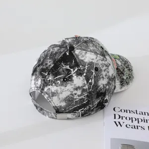 Black and white tie-dye baseball cap with sparkling rhinestones and chic butterfly details.