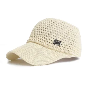 Close-up view of the sparkling rhinestone M logo and breathable mesh weave on the summer cap.