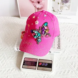 Rhinestone butterfly pink baseball cap detail showing sparkling gems and cute design.