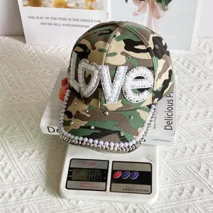 Trendy camouflage baseball cap for women with sparkling pearl LOVE patch detail.
