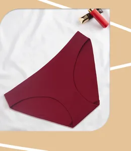 Detailed product shot of seamless wine red women mid-waist briefs displayed on white silk.