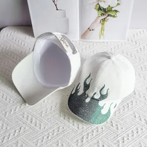 White baseball cap featuring sparkling rhinestone flame details, stylish streetwear design.