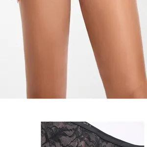 Close-up detail of women's black lace lingerie showing fabric texture and design trim.