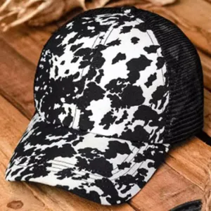 Cow print trucker hat with mesh back, stylish black and white baseball cap for women outdoor sports.