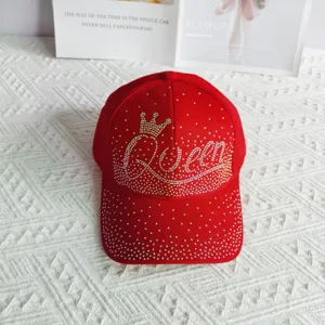 Vista dettagliata del berretto da baseball rosso con strass corona lettera Queen.