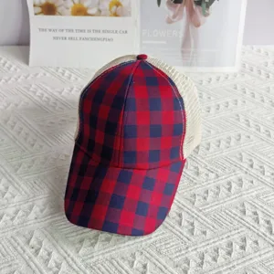 Red and blue plaid mesh trucker cap detail showing breathable fabric and classic pattern design.