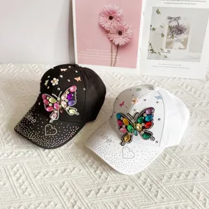 Fashion rhinestone butterfly baseball cap for women, stylish sunshade hat, black and white design.