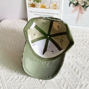 Detailed view of the interior and lining of a stylish camouflage baseball cap for women.