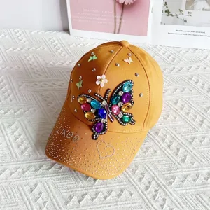 Detailed view of the stylish yellow rhinestone butterfly baseball cap, fashion sun hat for women.