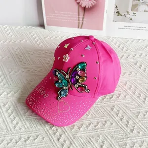 Pink rhinestone butterfly baseball cap for women, stylish bling sun hat with sparkly diamonds.