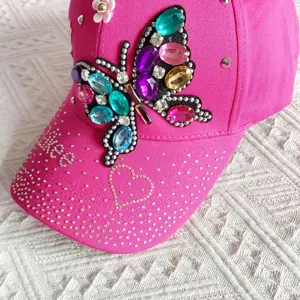 Pink rhinestone butterfly baseball cap, detailed close-up showing sparkly crystals.