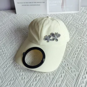 Quick-drying baseball cap with rhinestone butterfly, extended brim and solar cooling fan visor.