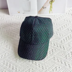 Rhinestone diamond lattice baseball cap detail, sparkling green crystals on dark fabric hat.