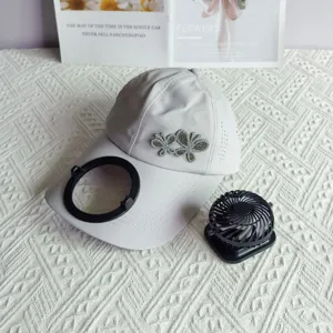 Quick-dry baseball cap with rhinestone butterfly decor and portable fan for summer sun protection.