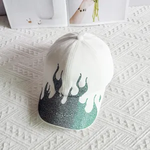 Detailed view of rhinestone flame baseball cap, stylish white streetwear hat with sparkling crystals.