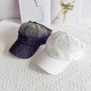 Detail shot of sparkling rhinestone baseball caps in dark and white colors, rhinestones bling.