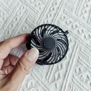 Portable mini black round fan component detail view, excellent personal cooling accessory.