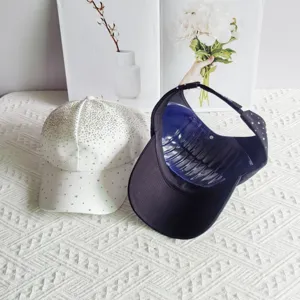 Detailed view of rhinestone baseball cap and empty top sun hat showing sparkling details