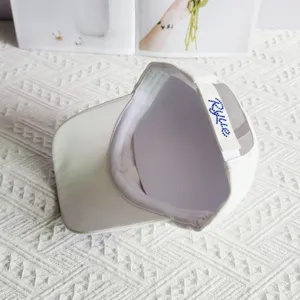 Detail view of white baseball cap with sparkling rhinestone strap and clean interior lining.