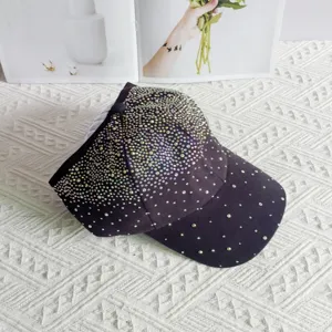 Close-up detail of black half-empty top baseball cap decorated with sparkling rhinestones.