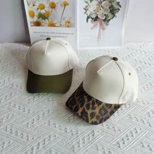 Detailed view of colorblock and leopard print cotton baseball caps, five-panel design.