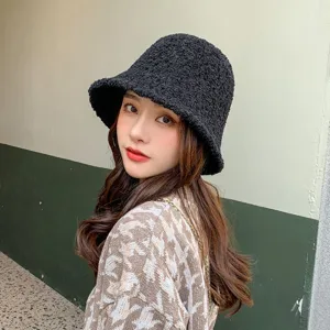 Detailed view of black sherpa fleece bucket hat, cozy winter warm plush basin cap style.