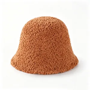 Close-up detail of the cozy brown teddy fleece bucket hat, soft texture, warm winter headwear.