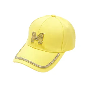 Bright yellow women's baseball cap with rhinestone M letter and crystal brim detail.