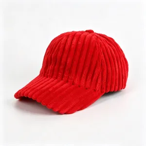 Red corduroy baseball cap detail view showing the soft ribbed texture and curved brim style.