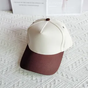Close-up view of the two-tone cotton baseball cap, featuring a clean off-white crown and brim.