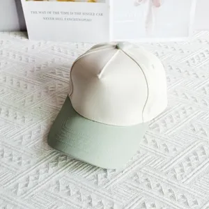 Two-tone cotton baseball cap with structured white crown and sage green brim for casual daily wear.
