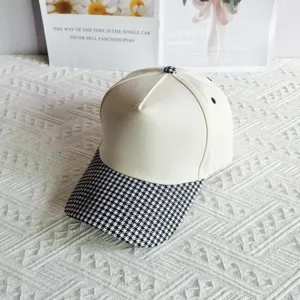 Cotton baseball cap with houndstooth brim, off-white crown, stylish sun hat for daily outdoor wear.
