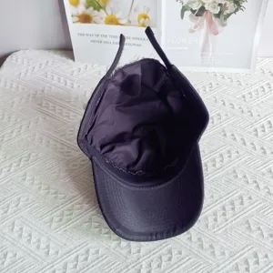 Detailed view of trendy black baseball wig hat with inner lining and adjustable straps style.