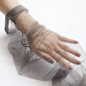 Sheer mesh arm cover detail showing delicate breathable fabric texture and elegant grey tone.