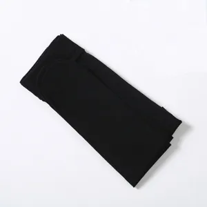 Black tights folded neatly detail view showing soft smooth fabric and fine texture.
