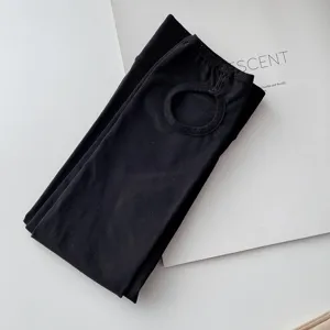 Black stirrup tights for women, casual elastic foot-opening leggings for spring and autumn daily wear.