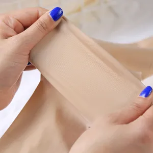 Detail view of skin-colored translucent tights showing high elasticity and smooth fabric texture.