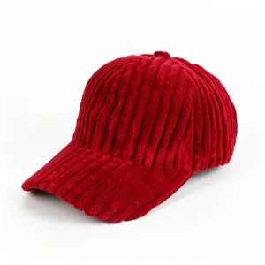 Closeup of red corduroy baseball cap, textured fabric detail, casual streetwear style.