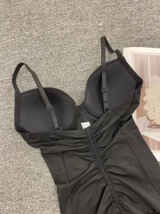 Detail shot of back and adjustable straps of black lace postpartum shapewear bodysuit with bra.