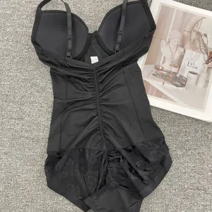 Black wireless shapewear bodysuit with built-in bra, tummy control, and lace trim details.
