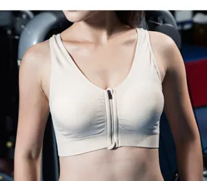 Detail view of a seamless front-zip sports bra in beige, offering comfort and support.