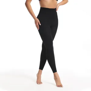Detailed view of women's black high-waist tights, stretchy fabric showing slim fit.
