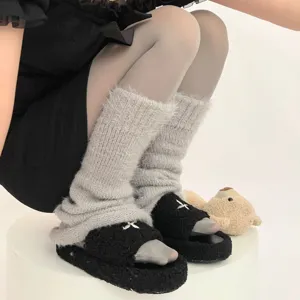 Detailed shot of winter velvet pantyhose and cozy leg warmers for stylish warm outfit.