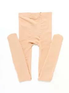 Detail view of skin-colored velvet tights pantyhose showing smooth texture and stretchy fabric.